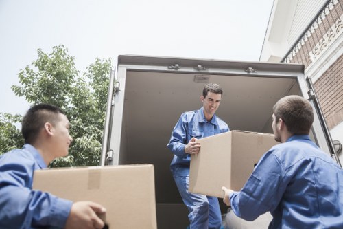 Local office movers handling equipment in a Soho building
