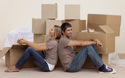 Professional movers handling boxes and furniture for a Soho home move