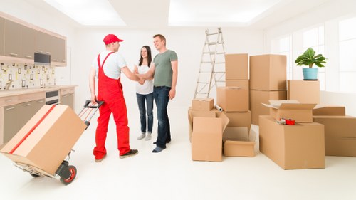 Professional movers packing furniture for a Soho apartment relocation