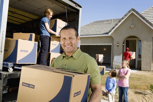 Professional movers transporting furniture through Soho