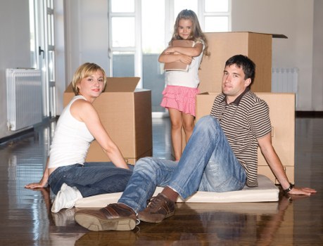 Professional movers handling furniture in a central London apartment